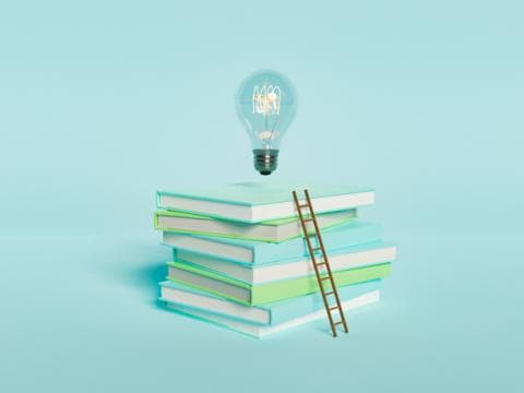 piles of books and light bulb